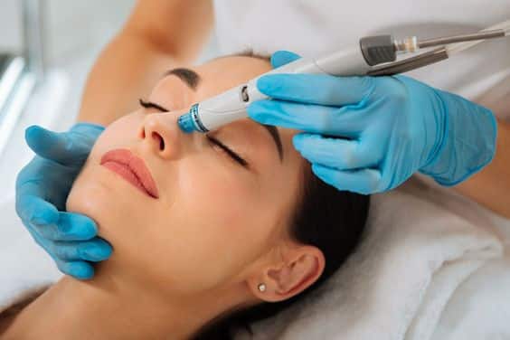 A woman's skin glowing after an Obaji Hydrafacial treatment.